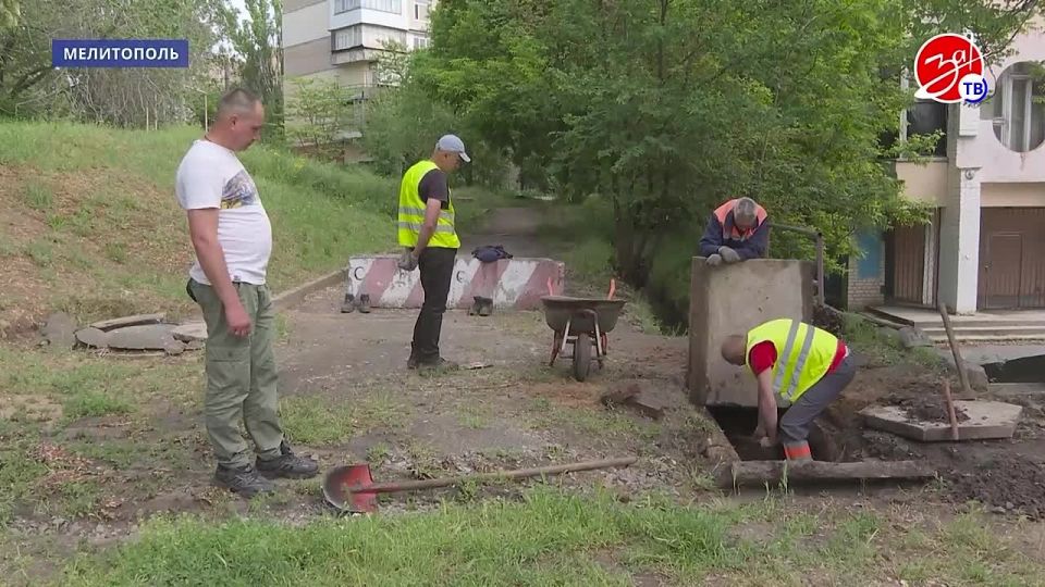 Сотрудники муниципального предприятия «Благоустройство» расчищают ливневую канализацию в центре Мелитополя